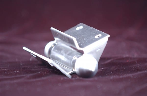 Upper view of stainless steel hinge on red background