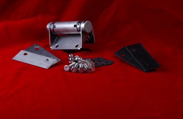 Variety of stainless steel door hinges with screws kept on red cloth